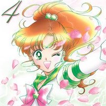 A pale anime girl with an auburn ponytail, green eyes, and a wide smile. She is wearing a green sailor-style collar with a pink bow.