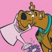 A cartoon Great Dane dog. He is brown with a large black nose and is wearing a blue-green collar.
