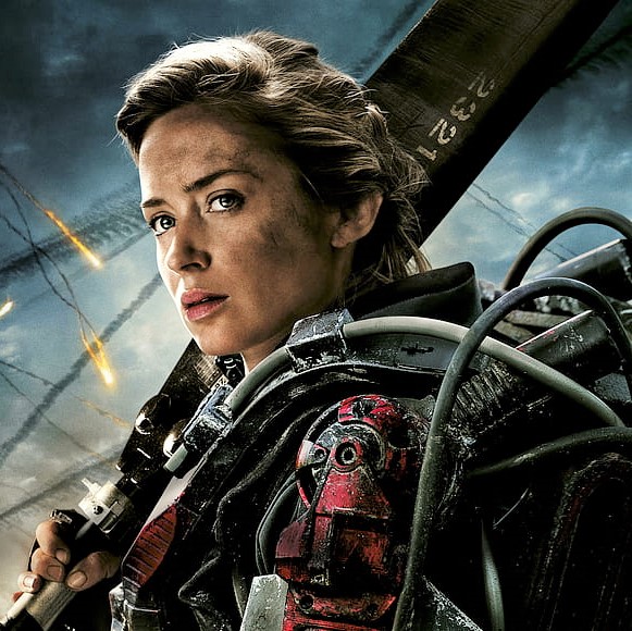 A square picture of Rita Vrataski from the movie Edge of Tomorrow as portrayed by Emily Blunt. She is a pale woman with blonde hair and blue eyes. She is wearing a complex mech suit.